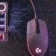 A computer mouse connected by cable to a dimly lit laptop, its cable running toward a glowing terminal window full of command-line text — illustrating giving a browser access to a HID device on Linux via a udev rule.